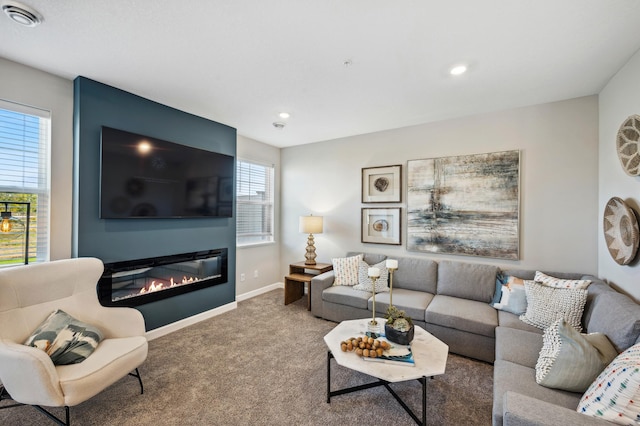 carpeted living room with a large fireplace