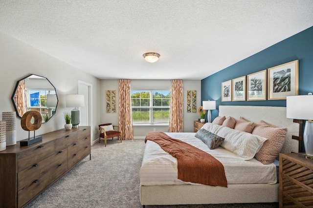 bedroom featuring light colored carpet and a textured ceiling