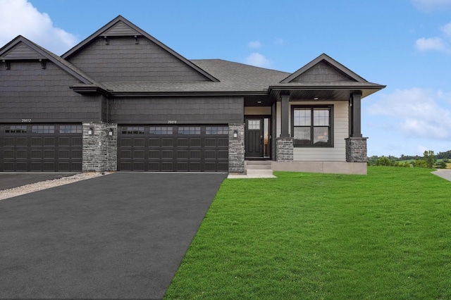 craftsman inspired home featuring a garage and a front yard