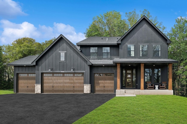 modern farmhouse style home featuring a porch, a garage, and a front lawn