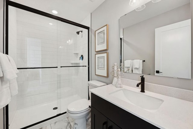 bathroom featuring walk in shower, vanity, and toilet