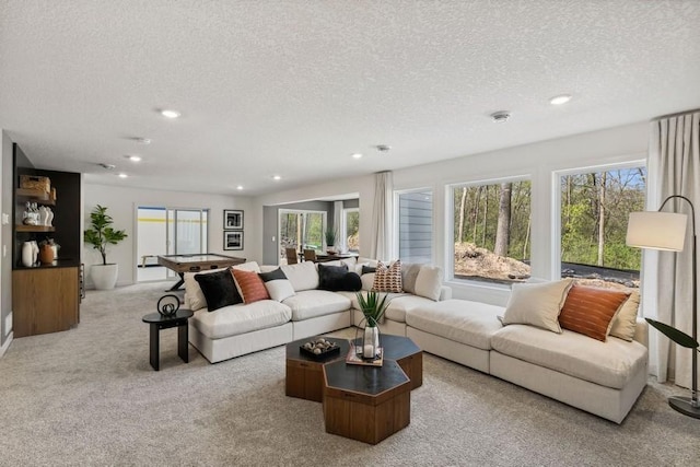 carpeted living room featuring a textured ceiling