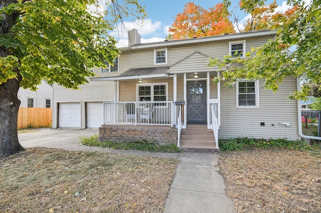 view of front of home featuring a porch and a garage