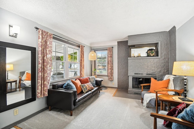 carpeted living room featuring a textured ceiling and a fireplace