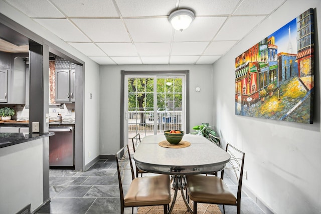 dining area with a paneled ceiling