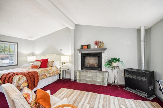 bedroom with dark colored carpet, lofted ceiling with beams, and heating unit