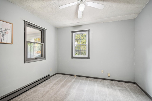 carpeted spare room featuring baseboard heating, ceiling fan, and a textured ceiling