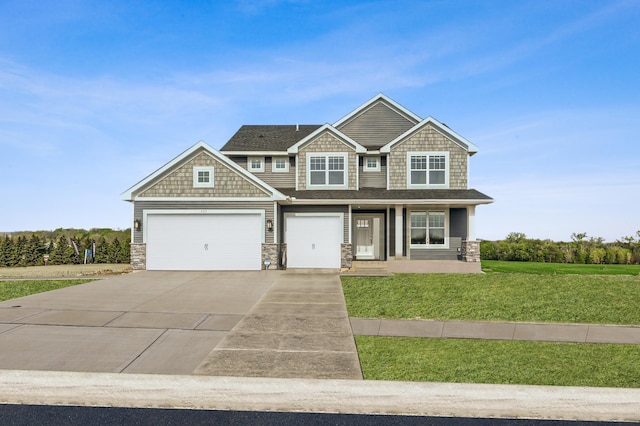 craftsman inspired home with a front yard and a garage