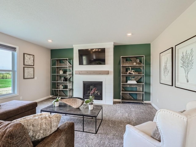 living room with carpet flooring and a fireplace