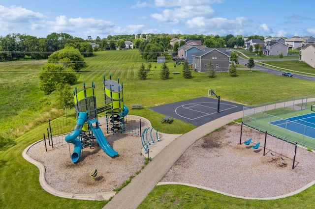 view of jungle gym with a lawn and basketball hoop