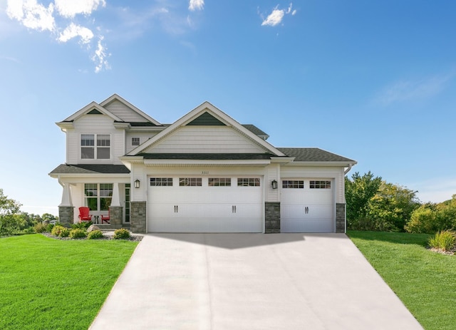 craftsman-style home featuring a garage and a front lawn