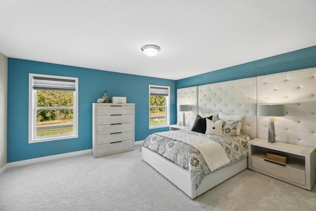 carpeted bedroom featuring multiple windows