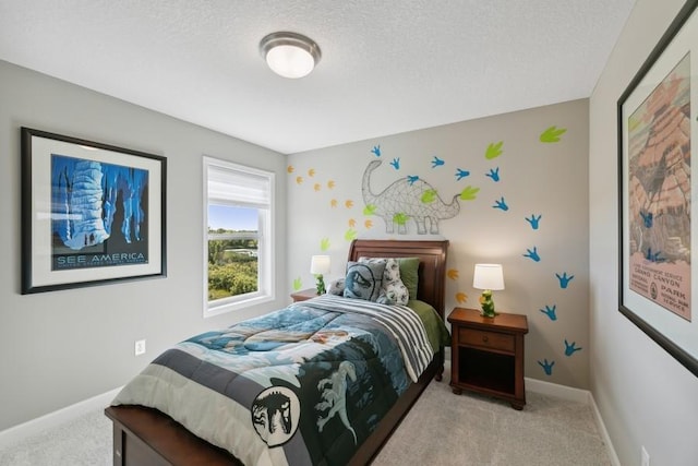 bedroom with light colored carpet and a textured ceiling