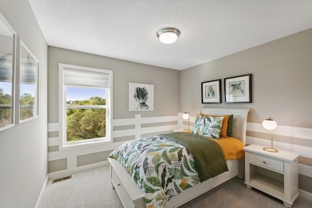 carpeted bedroom with a textured ceiling