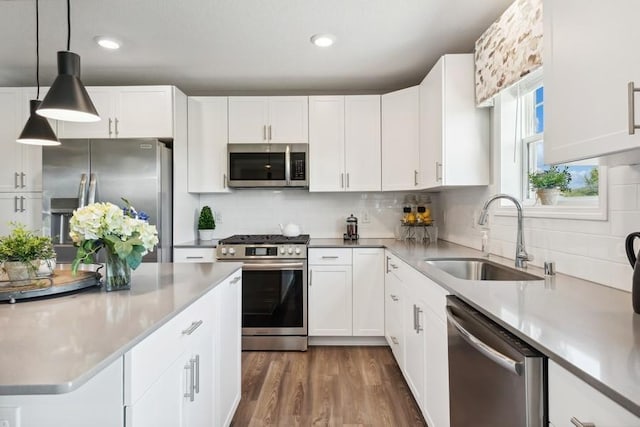 kitchen featuring white cabinetry, sink, and appliances with stainless steel finishes