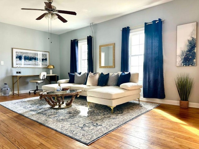 living room with wood-type flooring, a healthy amount of sunlight, and ceiling fan