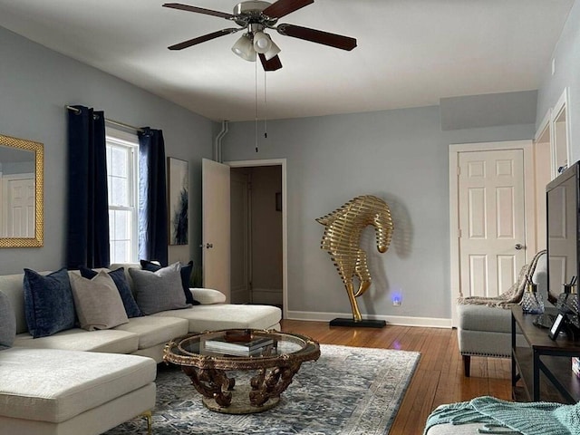 living room featuring wood-type flooring and ceiling fan