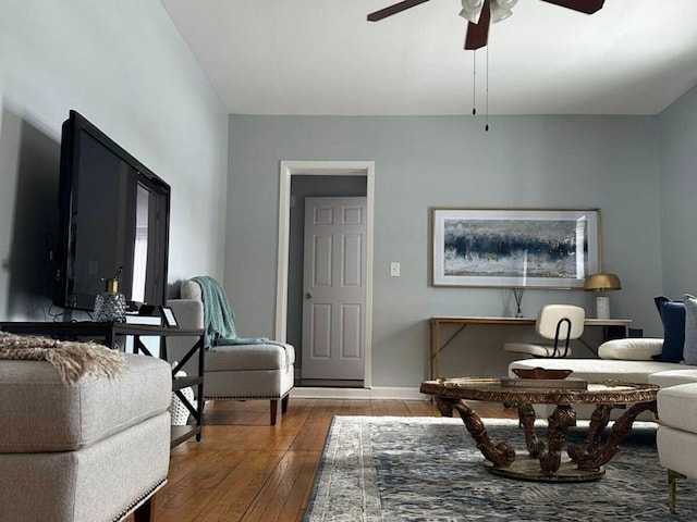 sitting room with hardwood / wood-style floors and ceiling fan