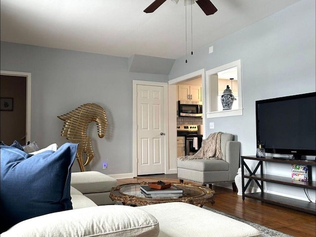 living room with dark wood-type flooring and ceiling fan