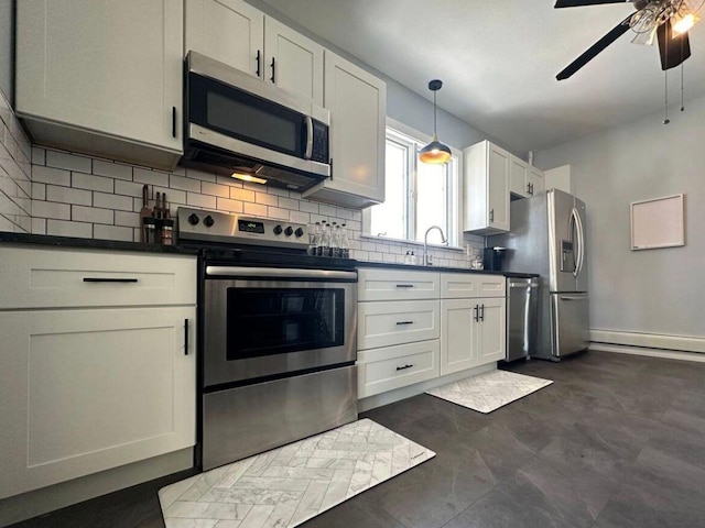 kitchen featuring white cabinetry, a baseboard radiator, hanging light fixtures, ceiling fan, and stainless steel appliances