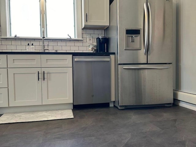 kitchen featuring sink, decorative backsplash, stainless steel appliances, and white cabinets