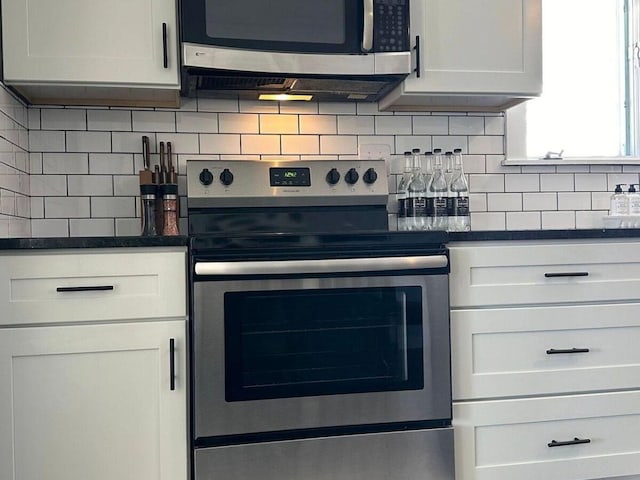 kitchen featuring white cabinetry, stainless steel appliances, and decorative backsplash