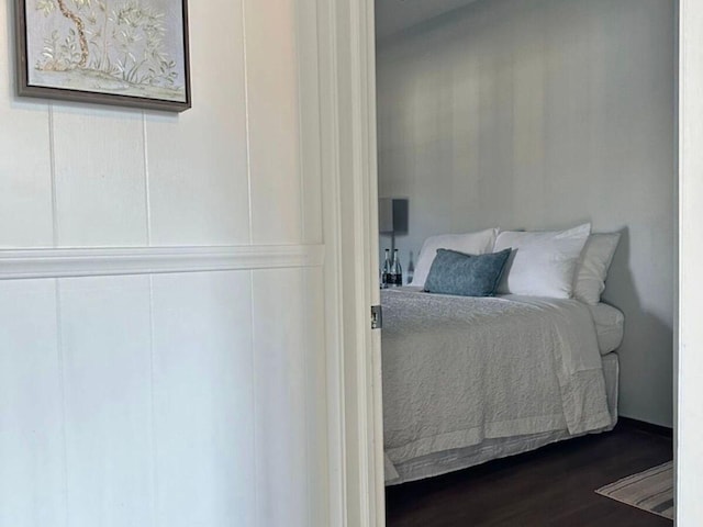 bedroom with dark hardwood / wood-style flooring