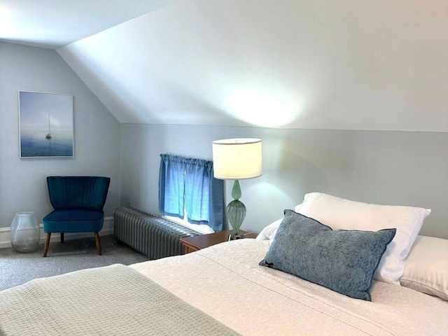 carpeted bedroom featuring lofted ceiling and radiator heating unit