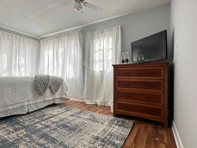 bedroom featuring wood-type flooring, a textured ceiling, and ceiling fan