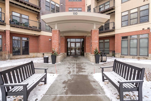 snow covered property entrance with french doors