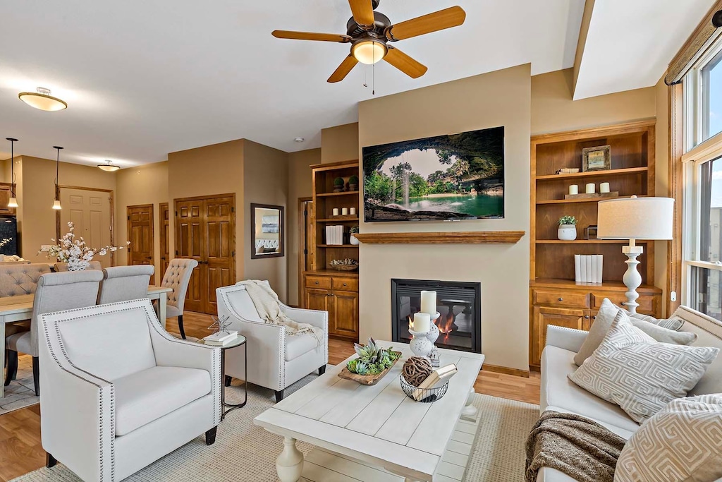 living room featuring ceiling fan and light wood-type flooring