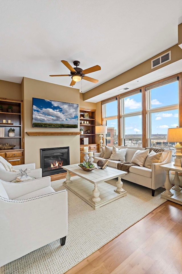 living room with ceiling fan and hardwood / wood-style floors