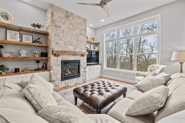 living room with ceiling fan, a fireplace, and hardwood / wood-style floors