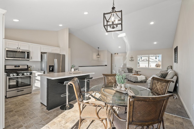 dining room featuring high vaulted ceiling, recessed lighting, an inviting chandelier, and baseboards