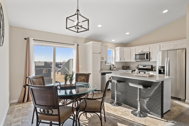 dining space featuring an inviting chandelier, baseboards, vaulted ceiling, and recessed lighting