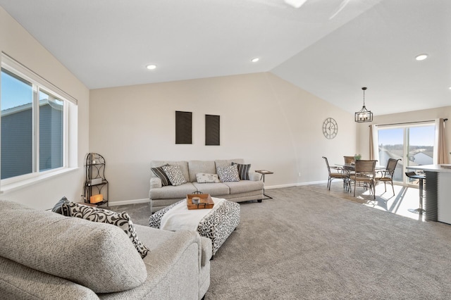 living room with carpet floors, baseboards, and lofted ceiling