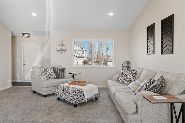 living room featuring carpet flooring, vaulted ceiling, and baseboards