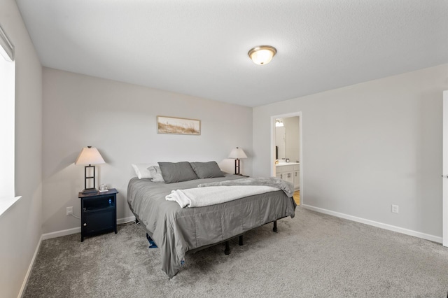 carpeted bedroom with baseboards and ensuite bathroom