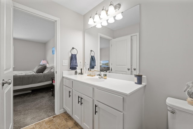 bathroom featuring connected bathroom, vanity, and toilet