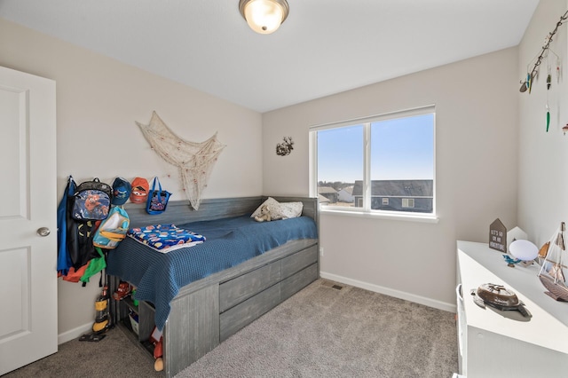 carpeted bedroom featuring visible vents and baseboards