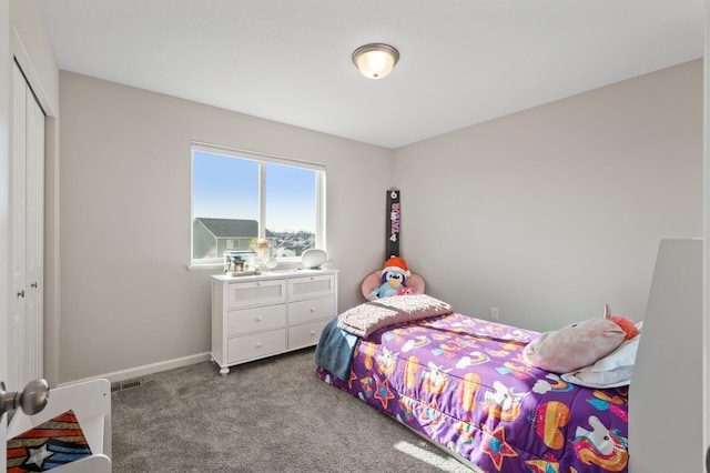 bedroom with carpet floors, visible vents, baseboards, and a closet