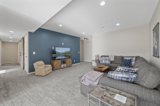 living area featuring a barn door, baseboards, carpet flooring, and recessed lighting