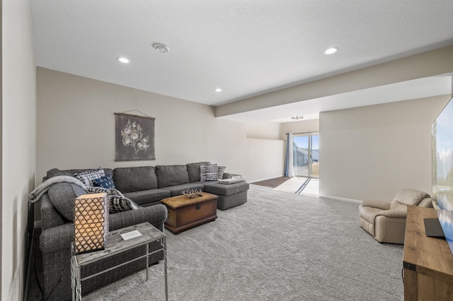 living area featuring carpet floors, recessed lighting, a textured ceiling, and baseboards