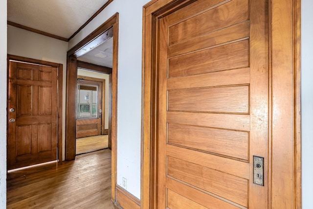 hall with crown molding and hardwood / wood-style floors