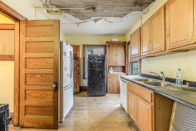 kitchen with sink, light hardwood / wood-style flooring, stainless steel fridge, white dishwasher, and black refrigerator