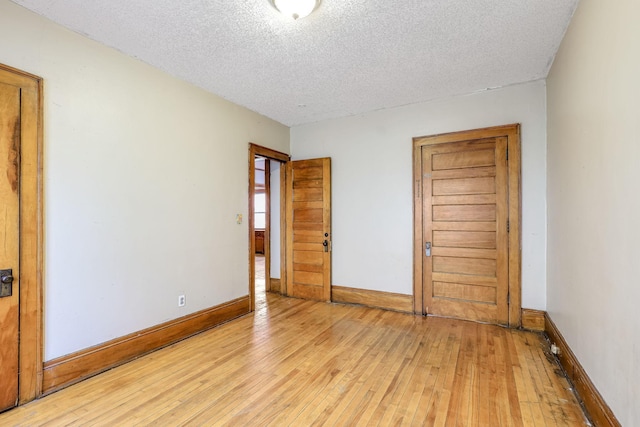 unfurnished bedroom featuring light hardwood / wood-style flooring and a textured ceiling