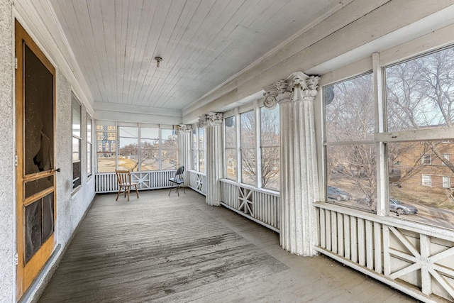 unfurnished sunroom with wood ceiling