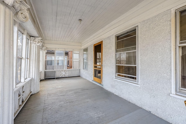 unfurnished sunroom featuring wood ceiling