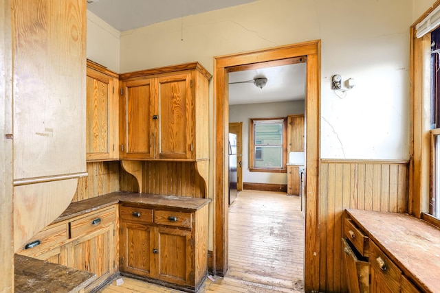 kitchen with wood walls and stainless steel refrigerator