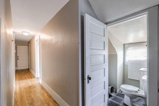 bathroom with hardwood / wood-style floors and toilet